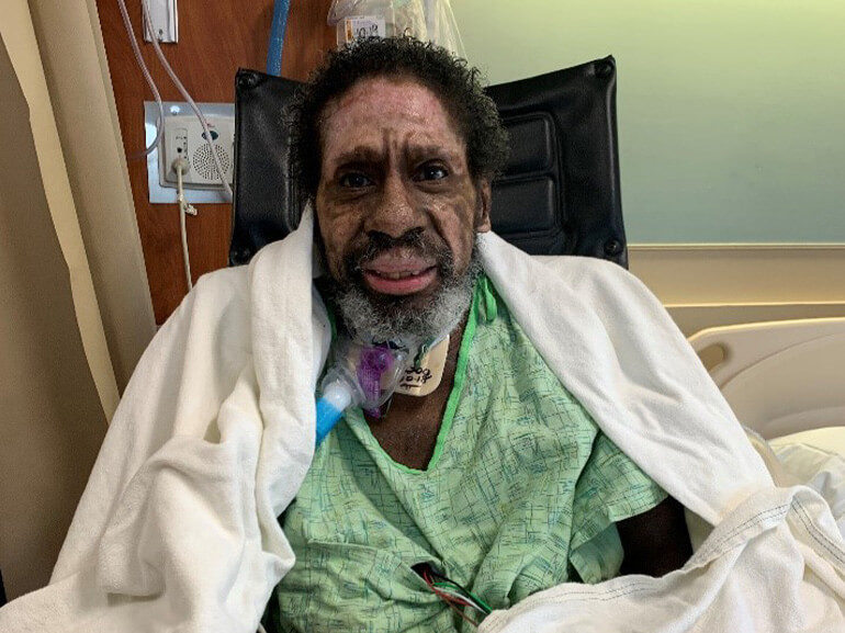 Wilbert Jones smiling for a photo in the hospital during his recovery.