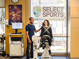 A male physical therapist working with a female athlete. 