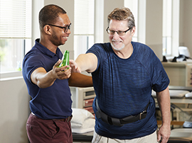 A brain injury patient working with a physical therapist on neurological exercises.