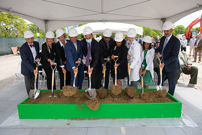 Photo of several people with shovels at the ceremonial groundbreaking of Rush University System for Health (RUSH).