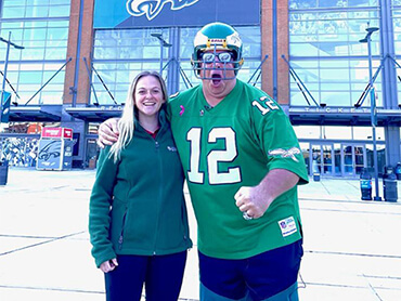 Dave Sommerfeld, standing with his physical therapist, wearing an Eagles jersey.