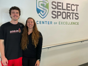 Liam Karey posing for a photo with his physical therapist.
