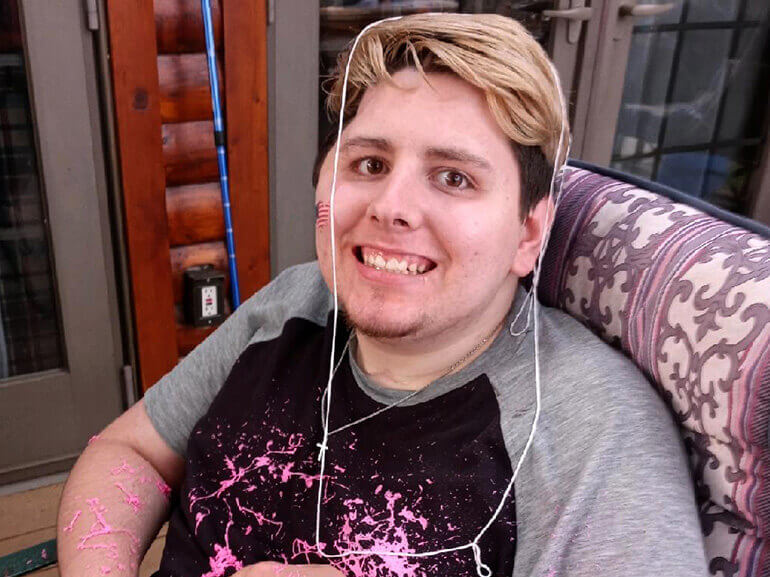 Ethan Pawlowski smiles for a photo after discharge from Regency Hospital.