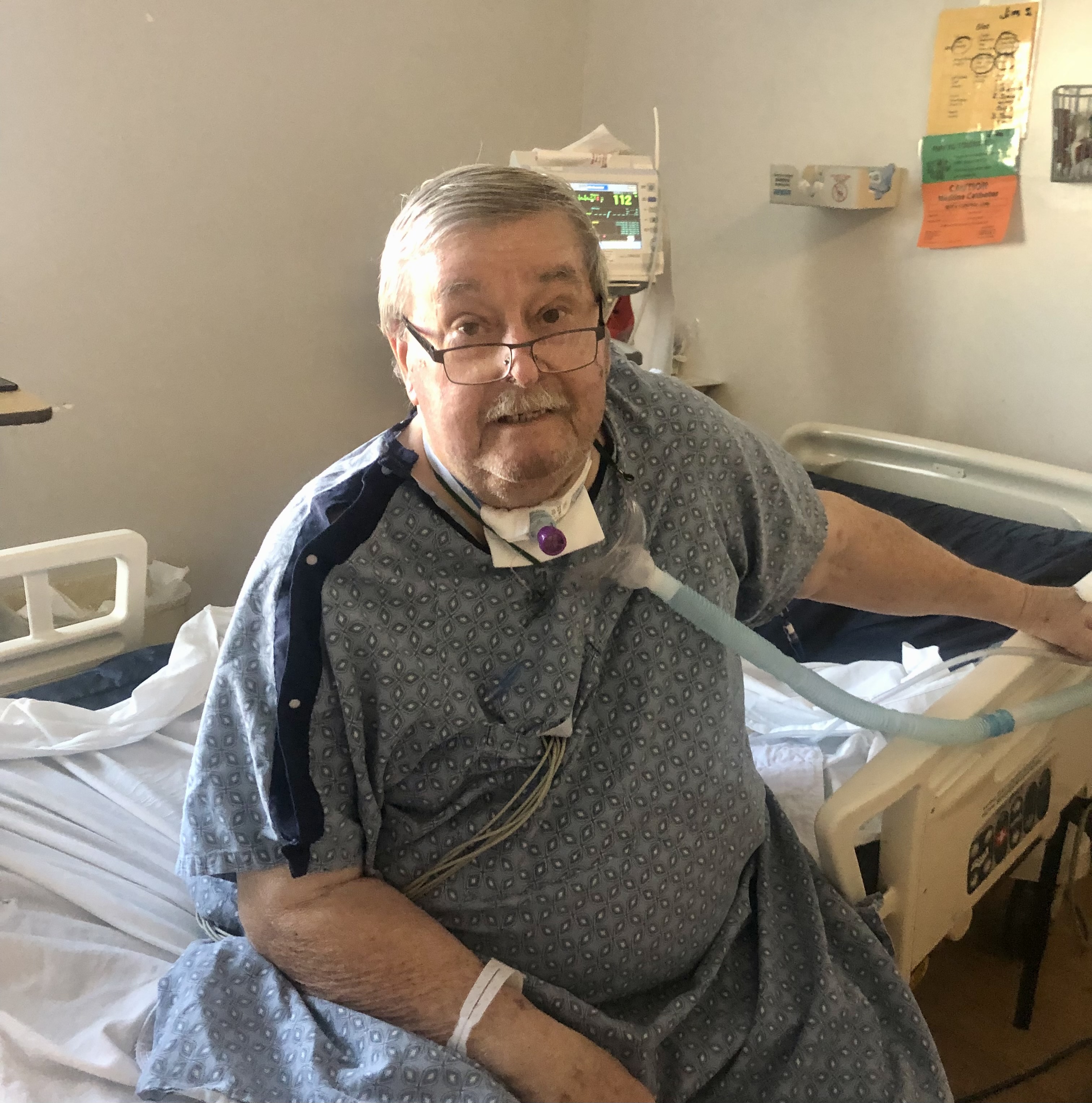 James Sims sitting up in his hospital bed for a photo.