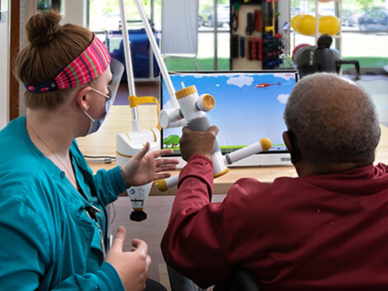 Neurological patient does brain exercises with therapist.