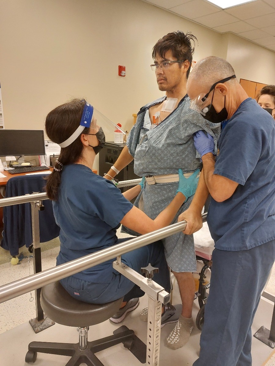Steven Nguyen working with his physicians on balancing exercises. 