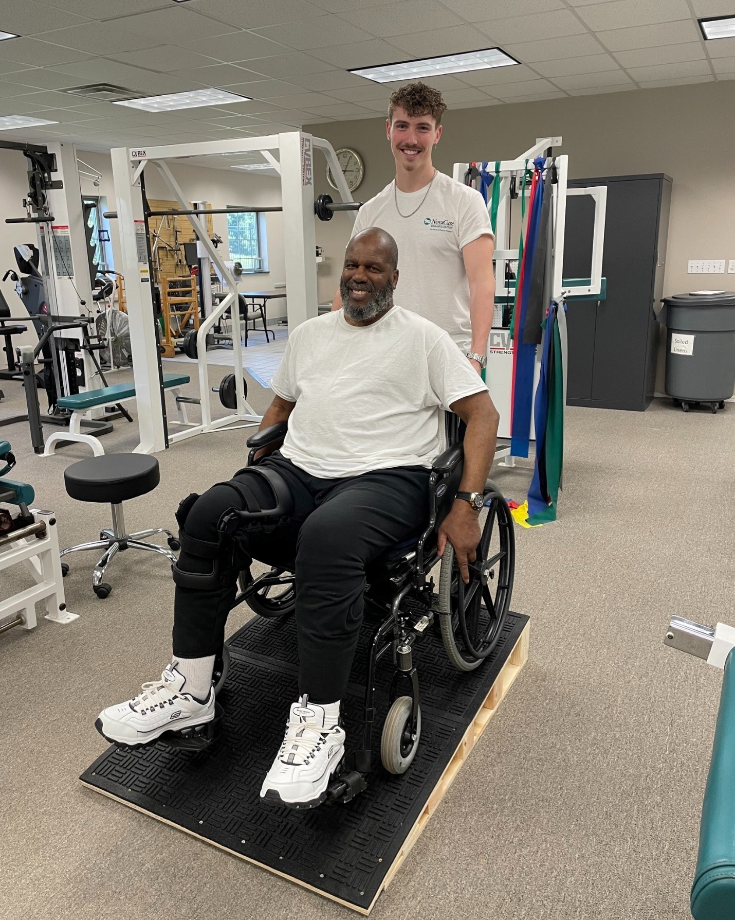 Patient in wheelchair in therapy gym.
