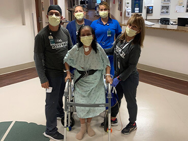 Altagracia posing for a photo with her care team in the hospital.