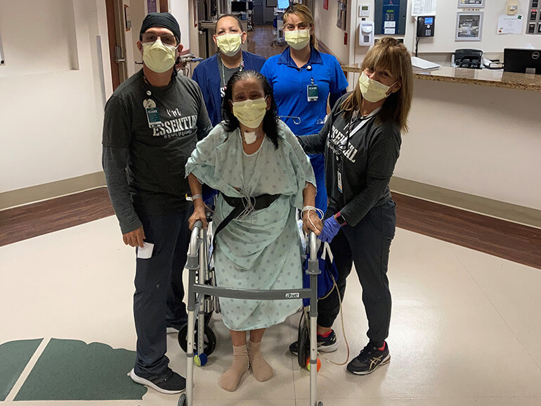 Altagracia posing for a photo in the hospital with her care team.