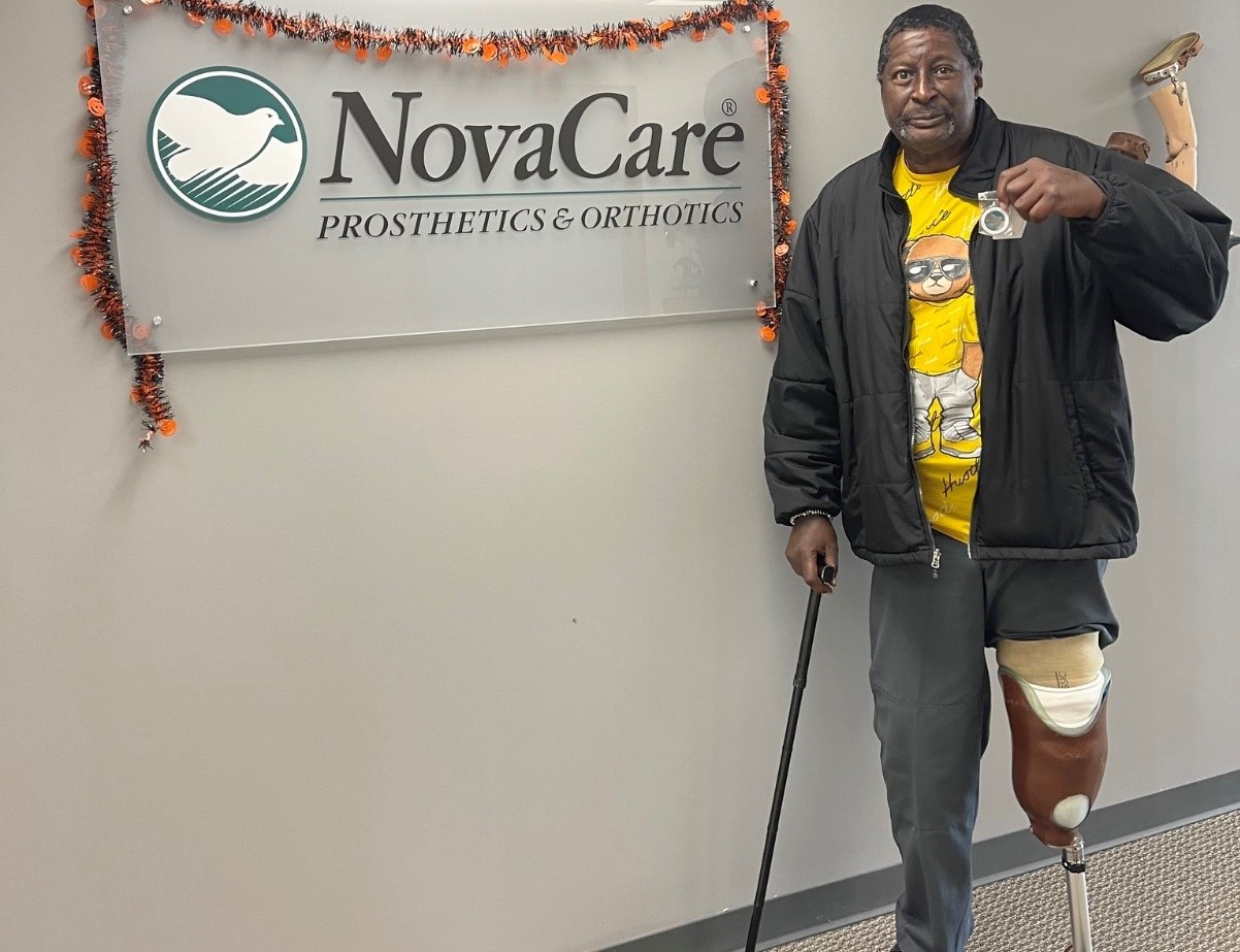 A patient named Robert posing for a photo with his prosthetic leg. 