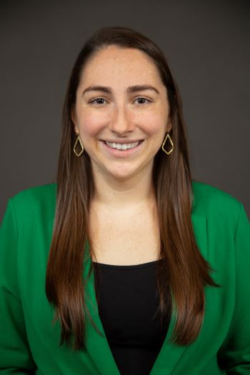 Gabrielle DeLauter smiles at the camera wearing a green shirt.