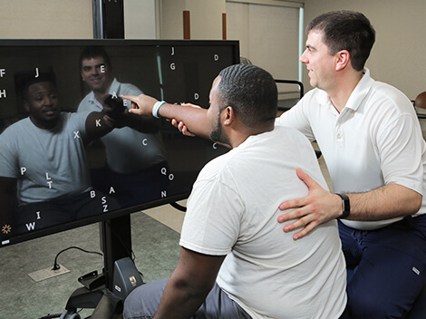 Patient uses technology for stroke recovery.