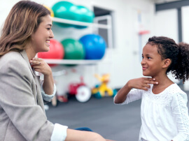 A physical therapist working with a pediatric patient
