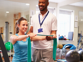 A female patient working with a physical therapist.