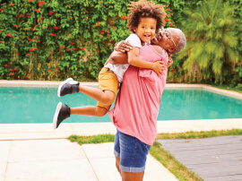 A previous cancer patient smiling with her family member.