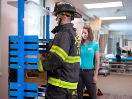 A firefighter learning safe work procedures to prevent injuries. 