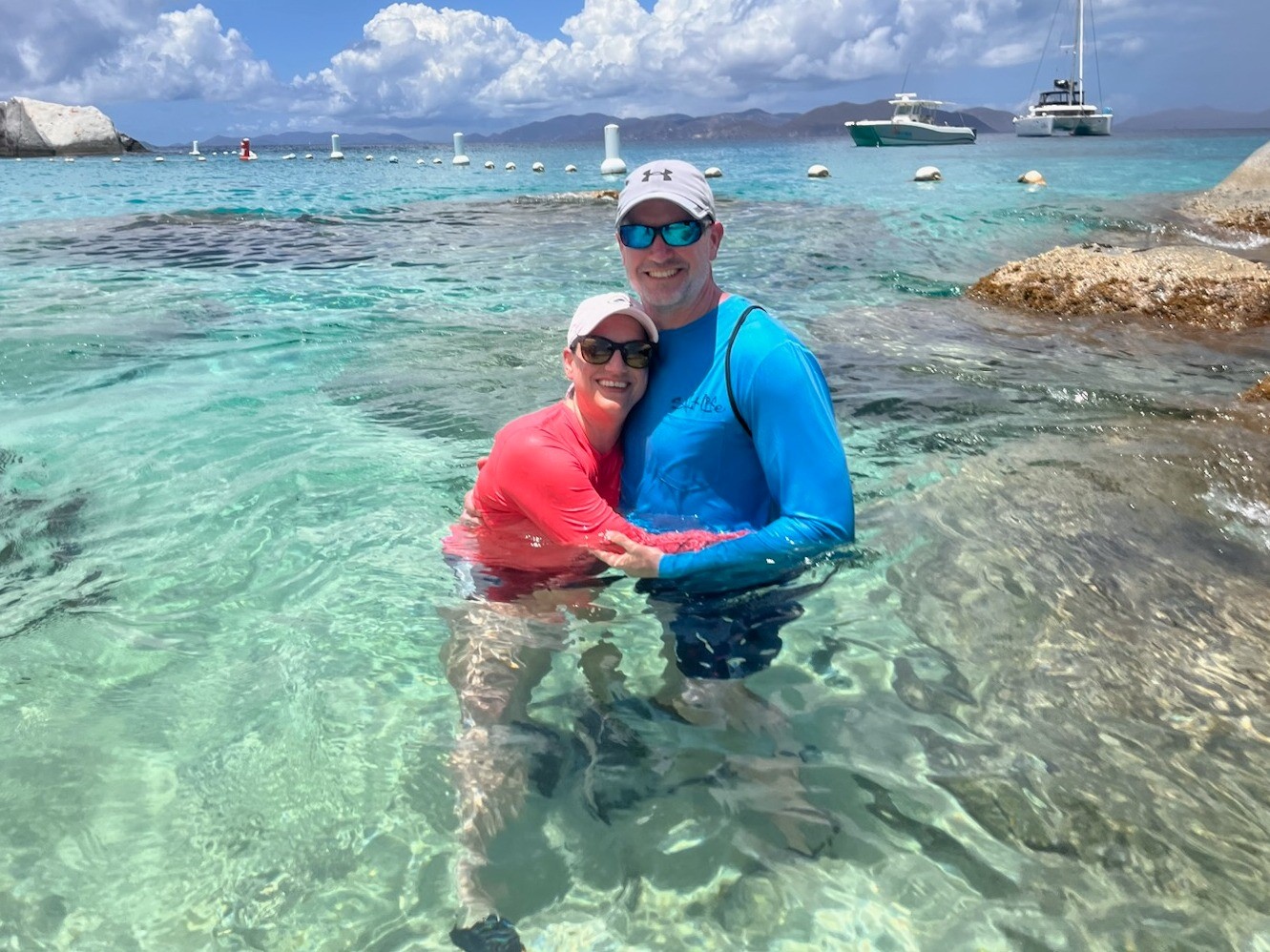 Amy Saye posing for a picture in the Caribbean with her husband.