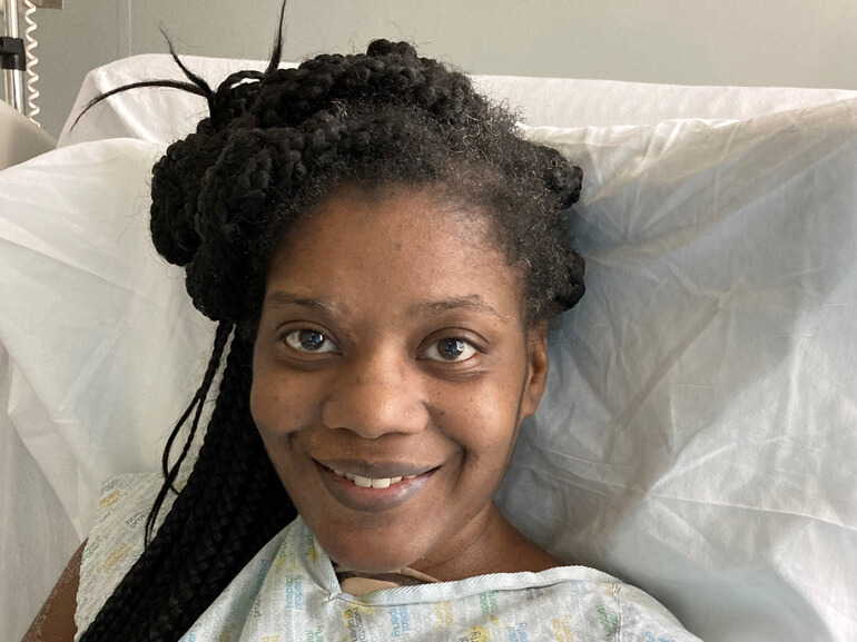 Shotonda smiling in her hospital bed.