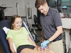 A physical therapist offering special hand therapy to a patient