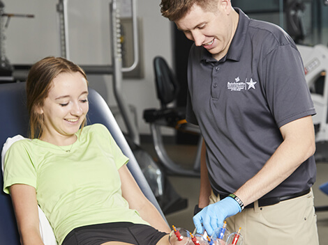 A physical therapist offering special hand therapy to a patient