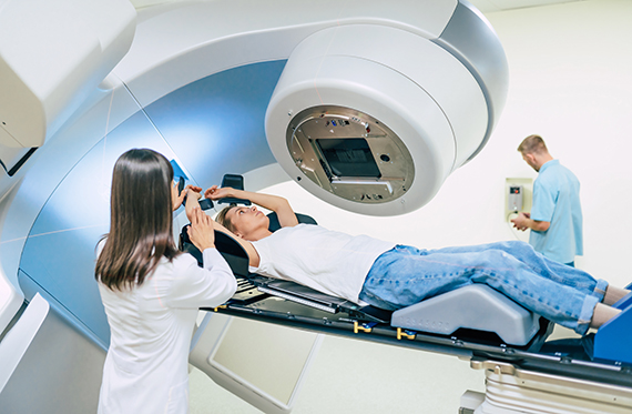 Woman laying in a machine to receive radiation for cancer 