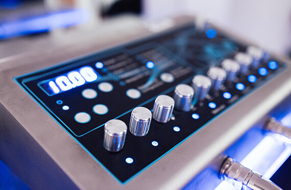 Close up of a control board with multiple dials, buttons and a screen that says "10.00"